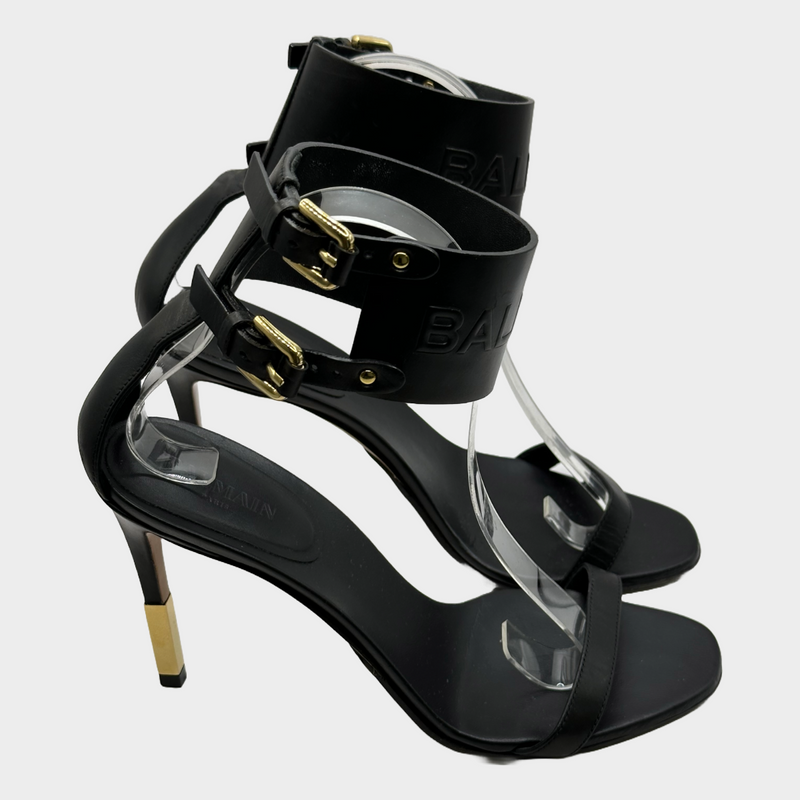 Balmain black leather ankle logo strap heels with gold tone hardware