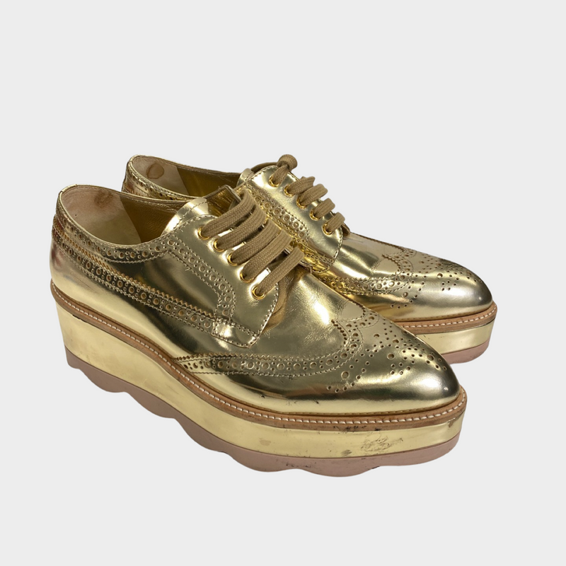 Prada women's gold patent leather platform shoes
