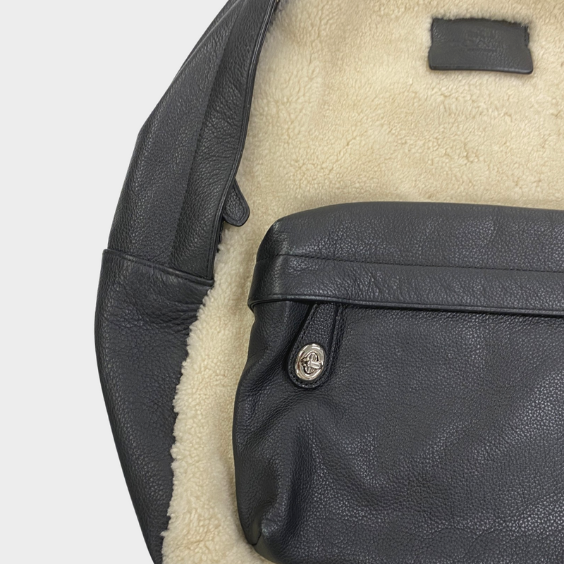 Coach men's black leather and cream fur backpack