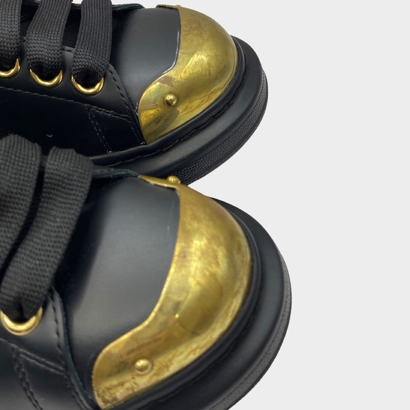 Alexander Mcqueen women's black leather raised-sole trainers with gold accents