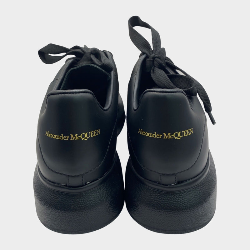 Alexander Mcqueen women's black leather raised-sole trainers with gold accents