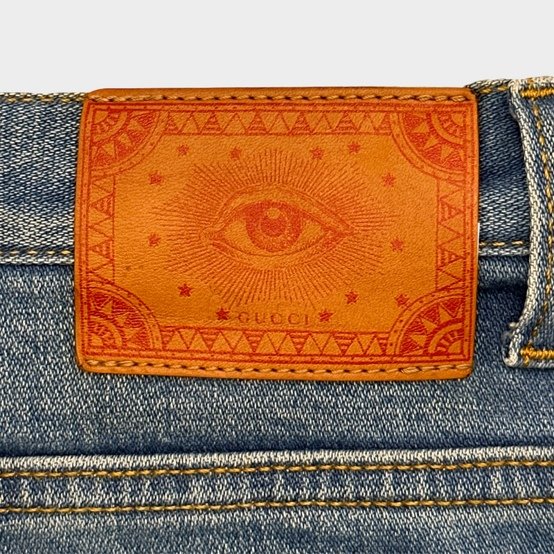 GUCCI women's blue distressed jeans with logo detail at the back