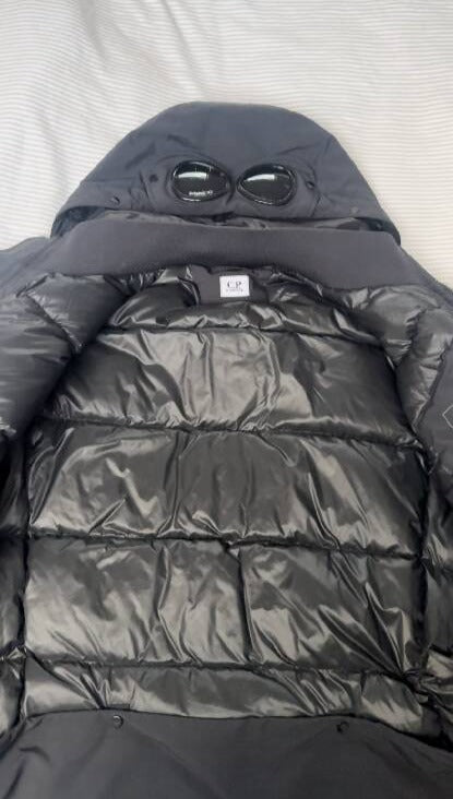 C.P Company men's black nylon down puffer jacket with hood and goggles