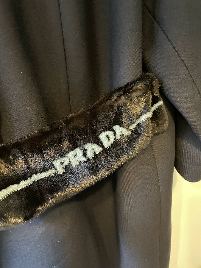 Prada women's navy wool coat with logo in mint fur trim at the back