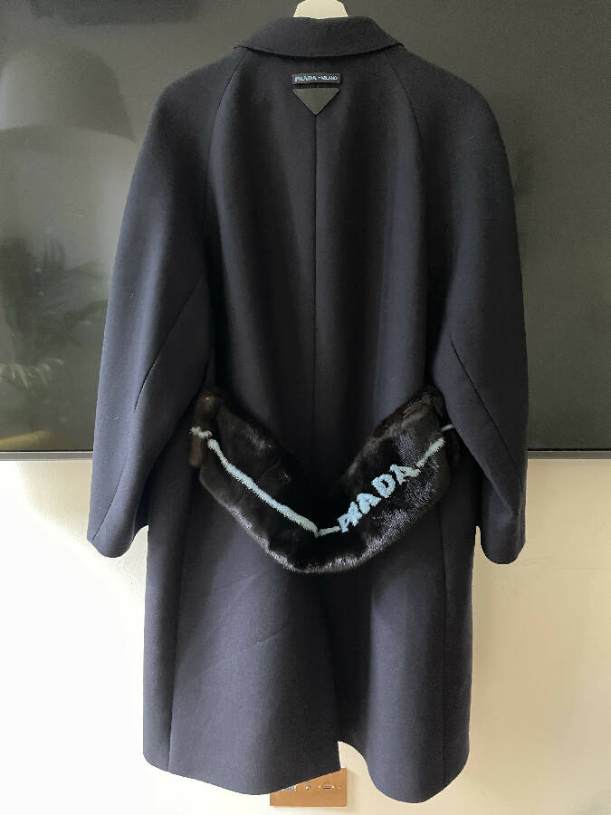 Prada women's navy wool coat with logo in mint fur trim at the back