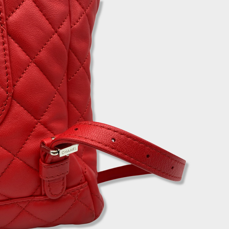 CHANEL bright red grained leather drawstring backpack with metal hardware