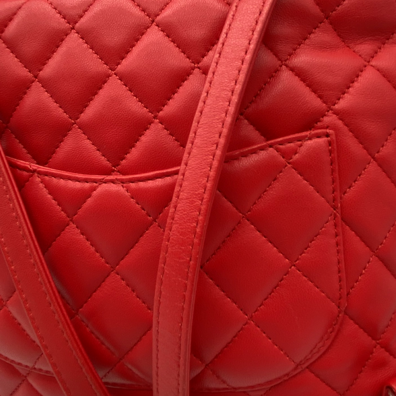 CHANEL bright red grained leather drawstring backpack with metal hardware