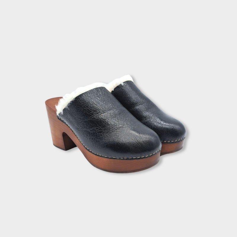 CHANEL black leather and ecru shearling clogs