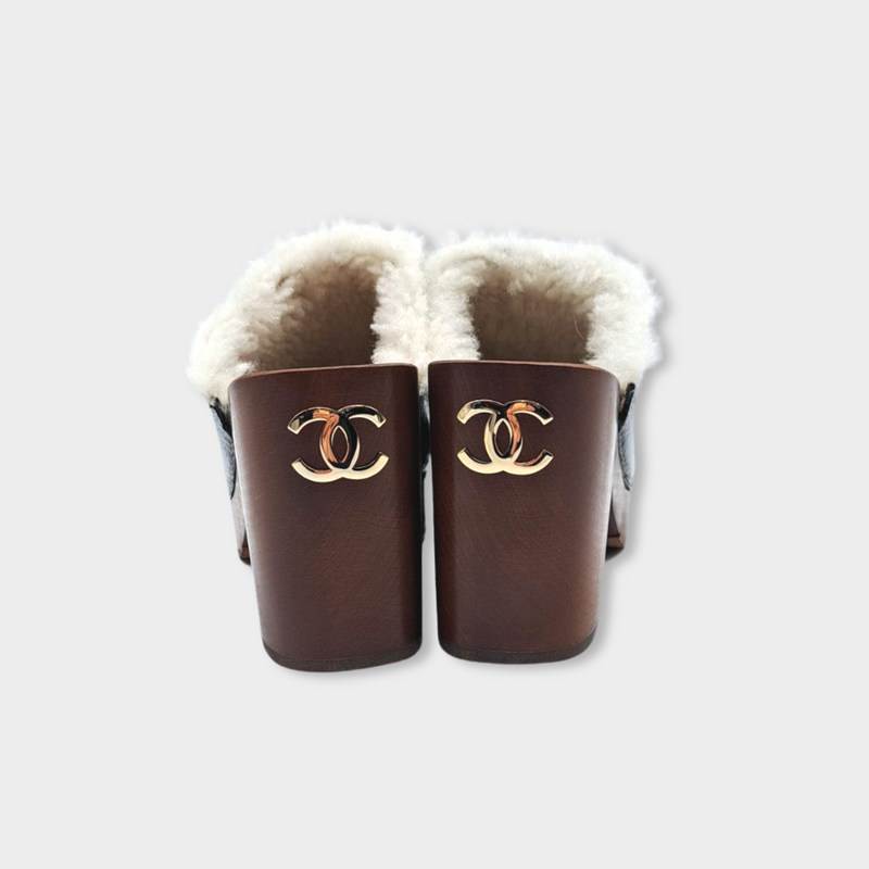 CHANEL black leather and ecru shearling clogs