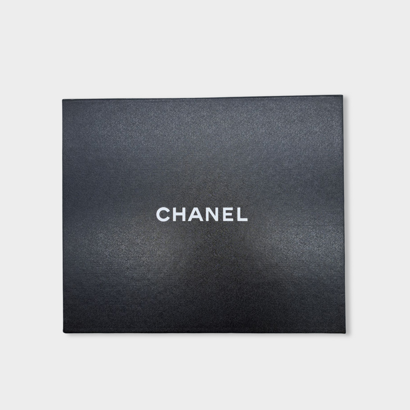 CHANEL black leather and ecru shearling clogs